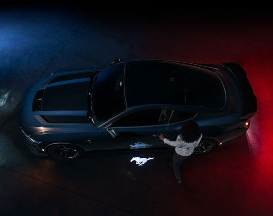 2024 Ford Mustang® Dark Horse™ model with a driver approaching the vehicle | Bell-McCall Company in Hamilton MT