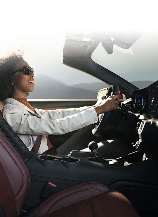 Person sitting in the driver’s seat of a 2024 Ford Mustang® convertible | Bell-McCall Company in Hamilton MT